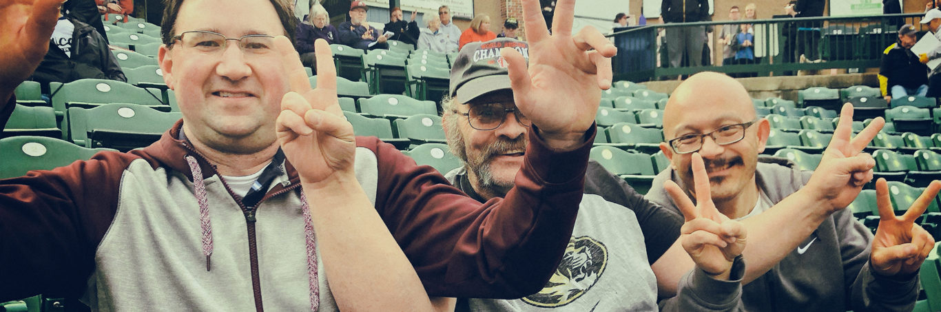 Group of three guys giving peace signs