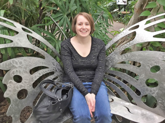 Melanie sitting on butterfly bench